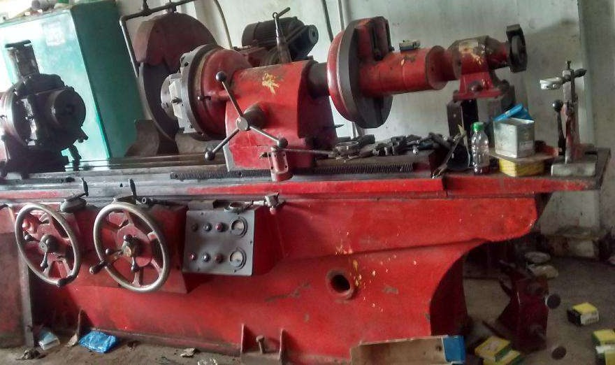 Cast iron component grinding machine setup in an industrial workshop