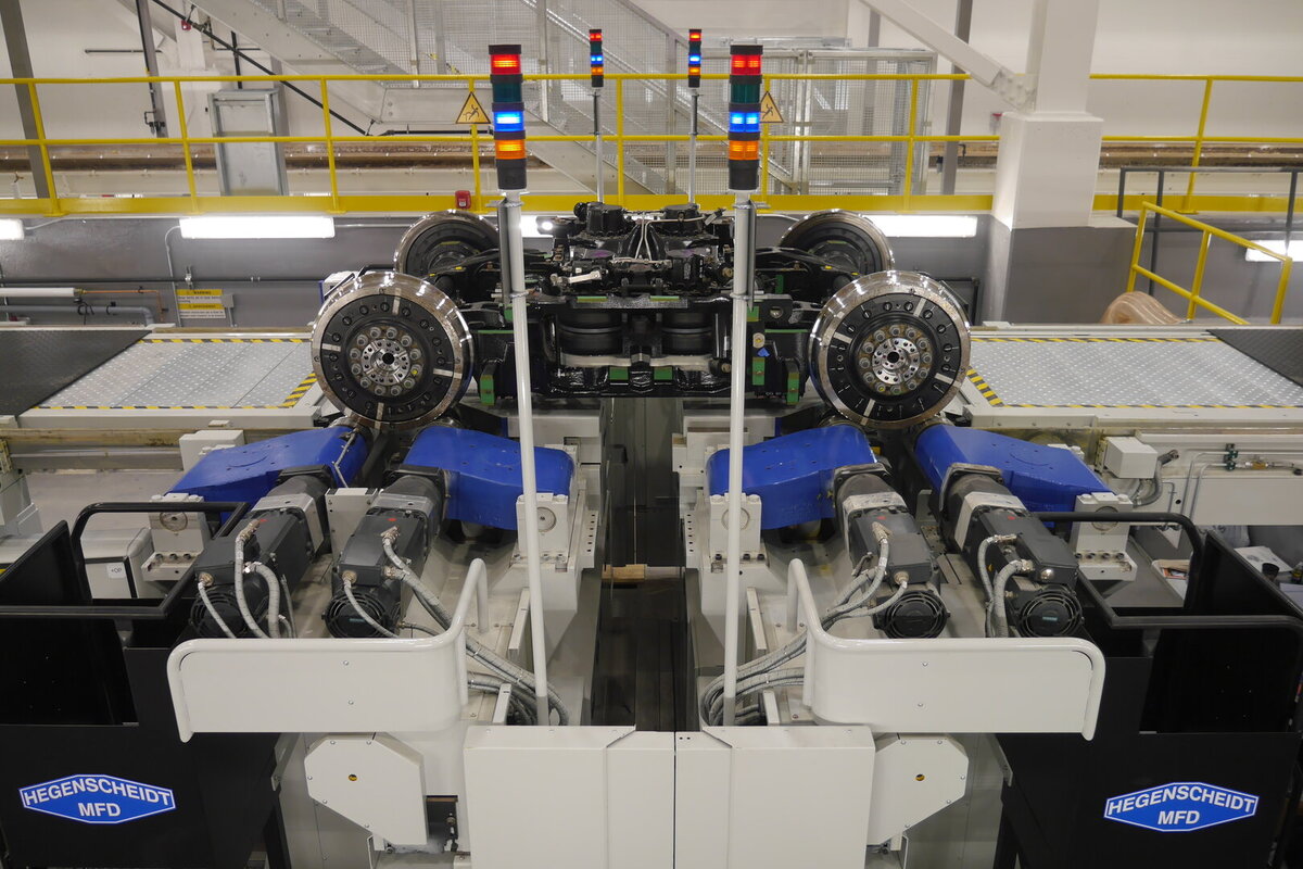 Railway wheelset maintenance machine with operator access area, suitable for illustrating service-friendly maintenance equipment for train wheel and axle workshops.